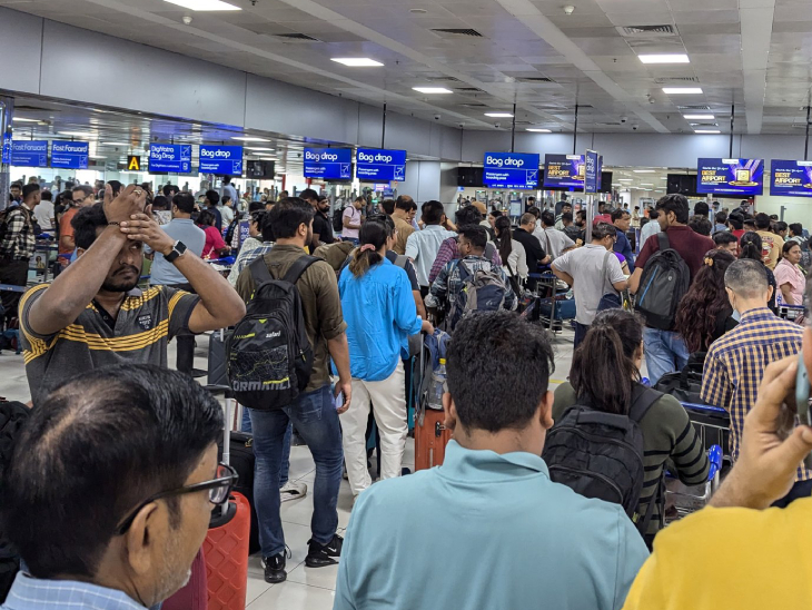 There is a crowd of passengers outside the Indigo counter at Terminal 2 of Delhi's IGI Airport.
