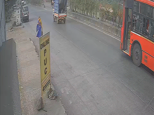 The woman is walking while talking on her mobile.