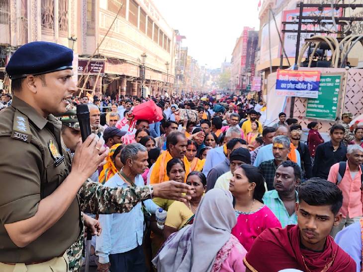 काशीमध्ये वेगवेगळ्या ठिकाणी 4 जणांचा मृत्यू: तीन भाविक बेशुद्ध पडले, प्रशासनाने रुग्णालयात नेले; प्रकृती सुधारल्यानंतर घरी पाठवले भाविकांच्या गर्दीला नियंत्रित करण्यासाठी घोषणा देताना पोलिस अधिकारी.