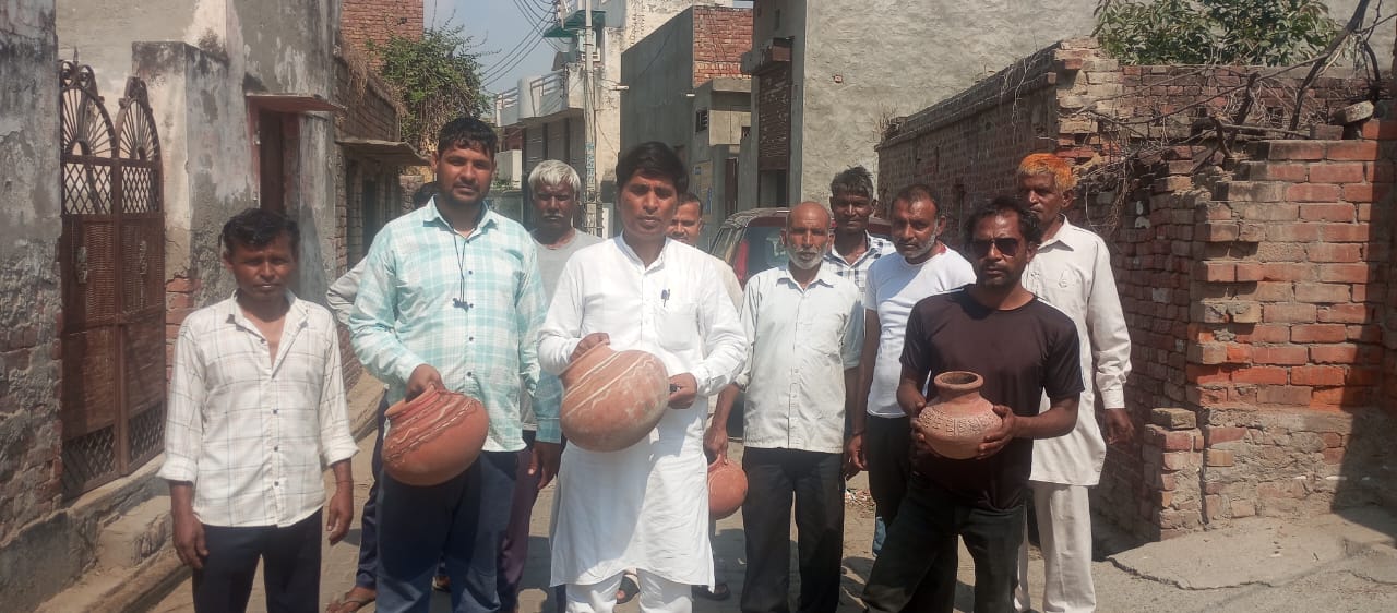 जिला पार्षद संजय बड़वासनियां और ग्रामीण प्रदर्शन करते हुए