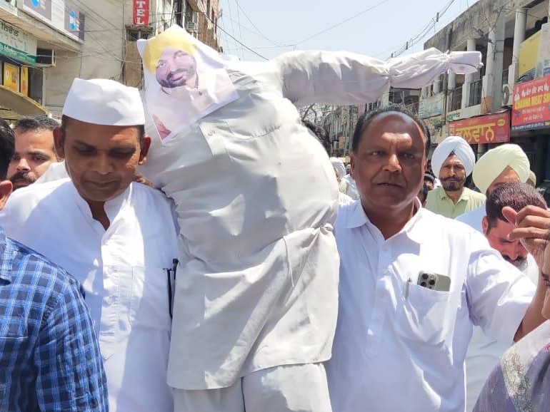 सीएम मान का पुतला ले जाते कांग्रेस कार्यकर्ता।