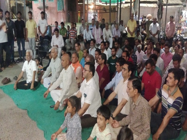 एक श्रद्धांजलि बैठक में बैठे लोग।