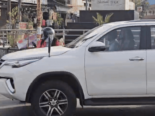 The car running with the professor's car hit the scooty riding woman.