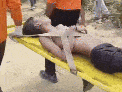 NDRF team carrying the dead body out of the pond.