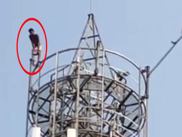young man climbed a mobile tower and did a high voltage drama