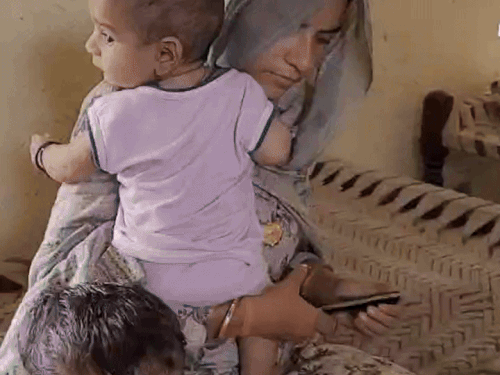 Sheela, wife of Lance Nayak Ashok Kumar with children in Mohammadpur village.