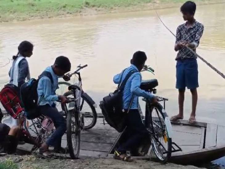 Children cross the river by placing a bicycle on the boat. They study in Gopalpur school.