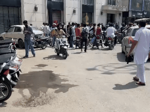 People present outside the showroom after the incident.