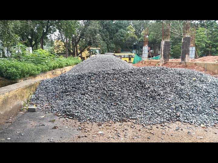 निर्माणाधीन भवन के सामने गिट्टी रखी गई है।