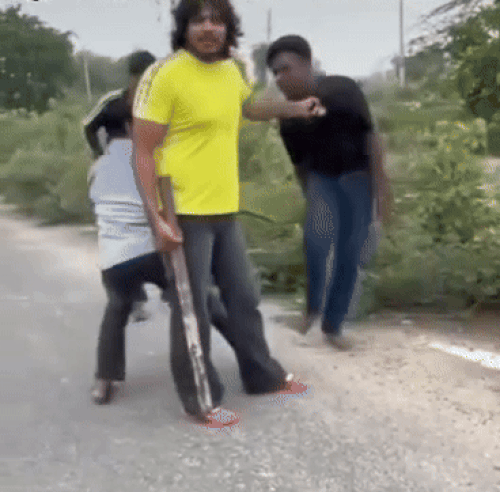 The gym operator holds the young man's giring and is hitting the young man with him.