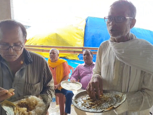 People eating mutton-rice in the party.