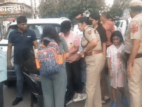 Sonipat Police Commissioner Mamta Singh helps the injured woman at Subhash Chowk