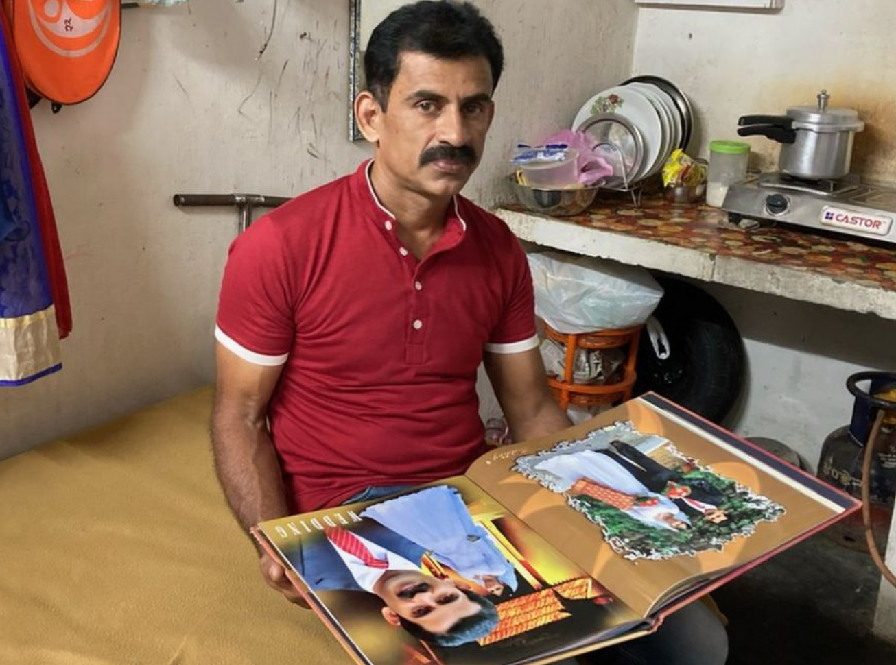 In the picture, Nimisha's husband Thomas showing the wedding album.