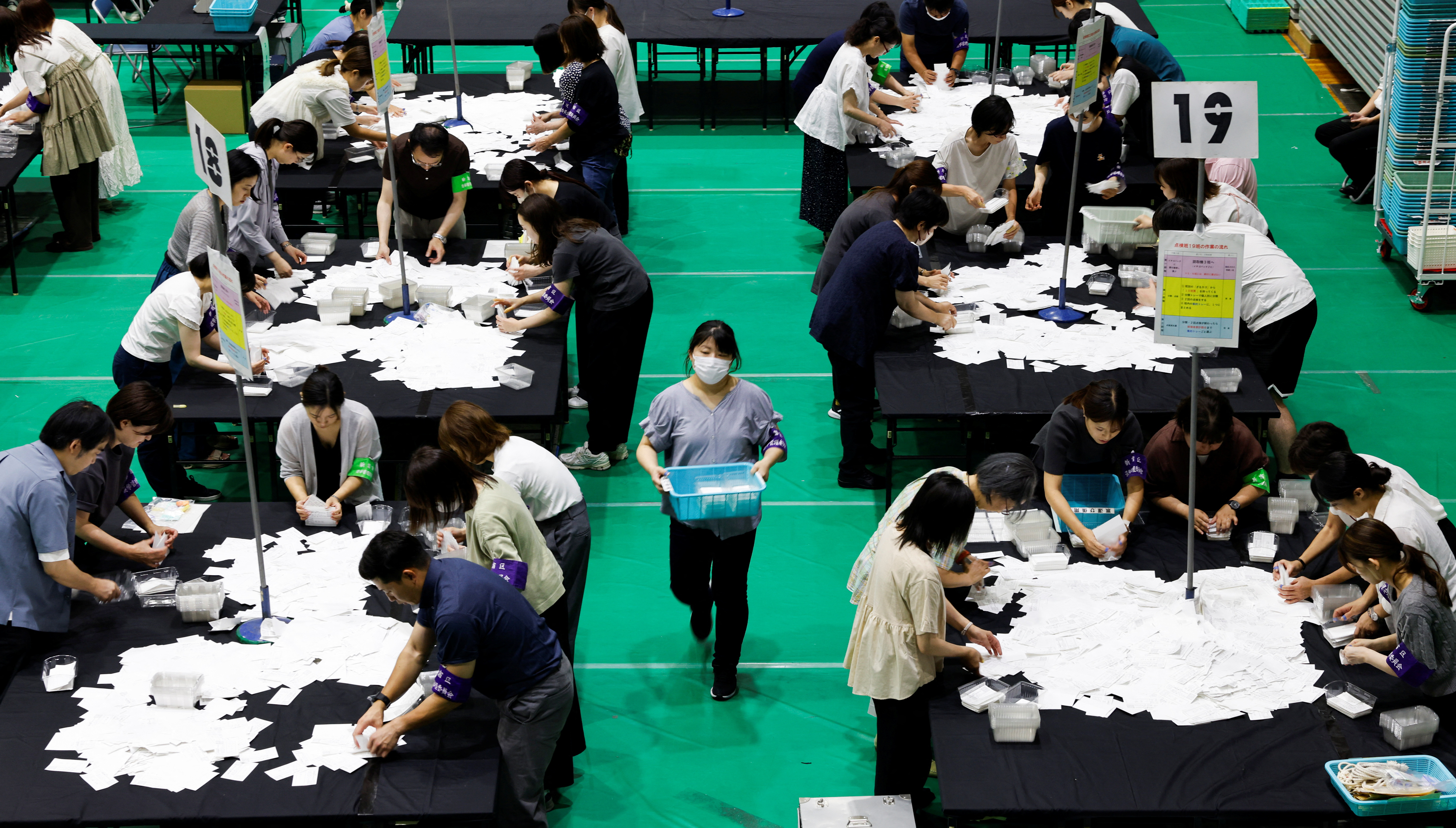 Officers at a counting center on Sunday for the election of the upper house in Tokyo counting votes.