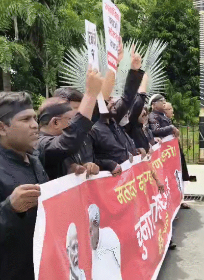Male MLA reached the assembly in black clothes with a banner in his hands against voter verification.
