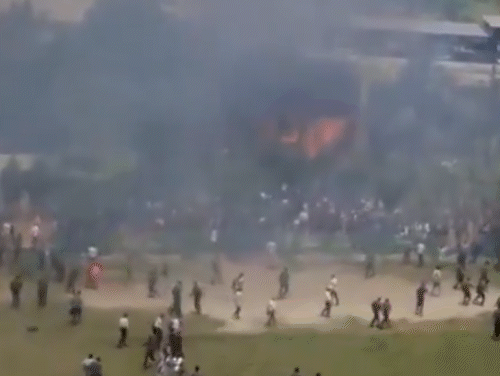 Flames arose from the aircraft and smoke spread on the campus. Students running away from school after the incident.