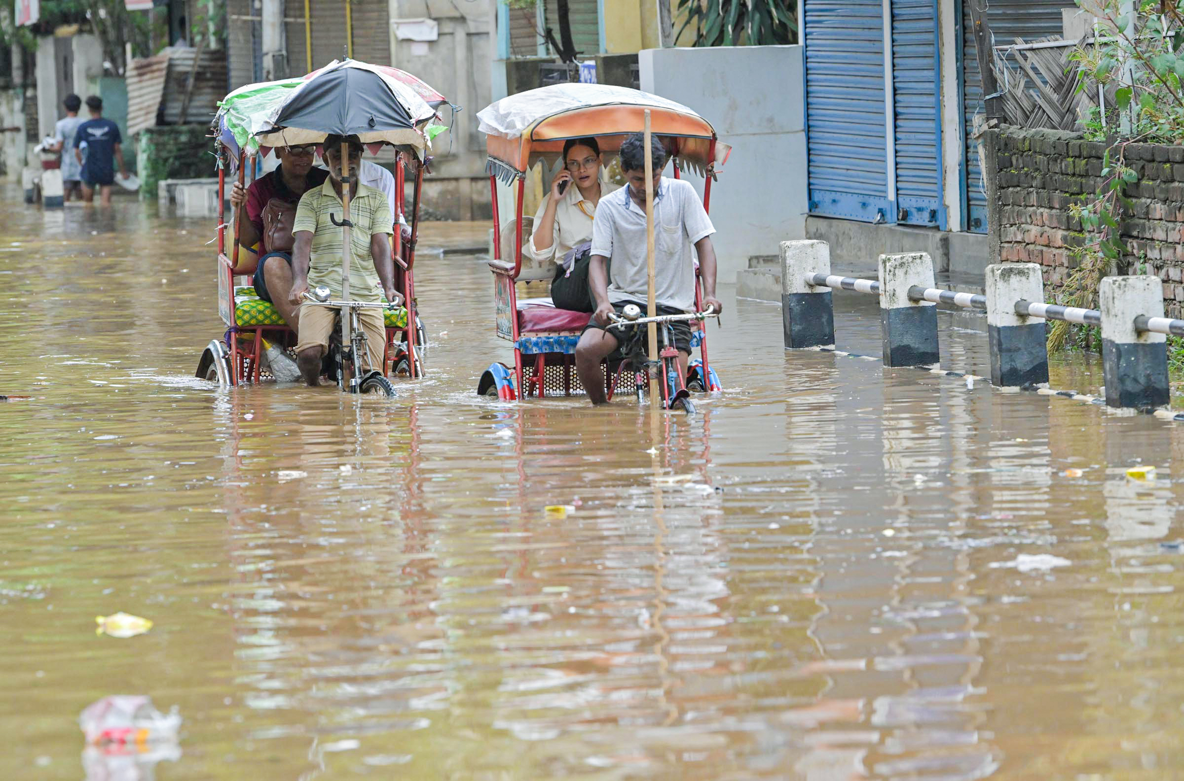 Guwahati received heavy rains on Tuesday. Rickshaw drivers carrying passengers from the road submerged in water.