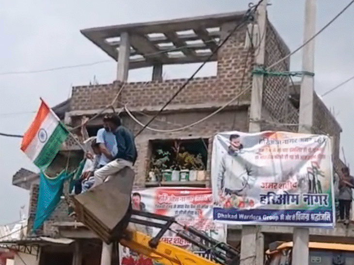 जेसीबी के पंजे पर चढ़कर ग्रामीणों ने तिरंगा लहराया।