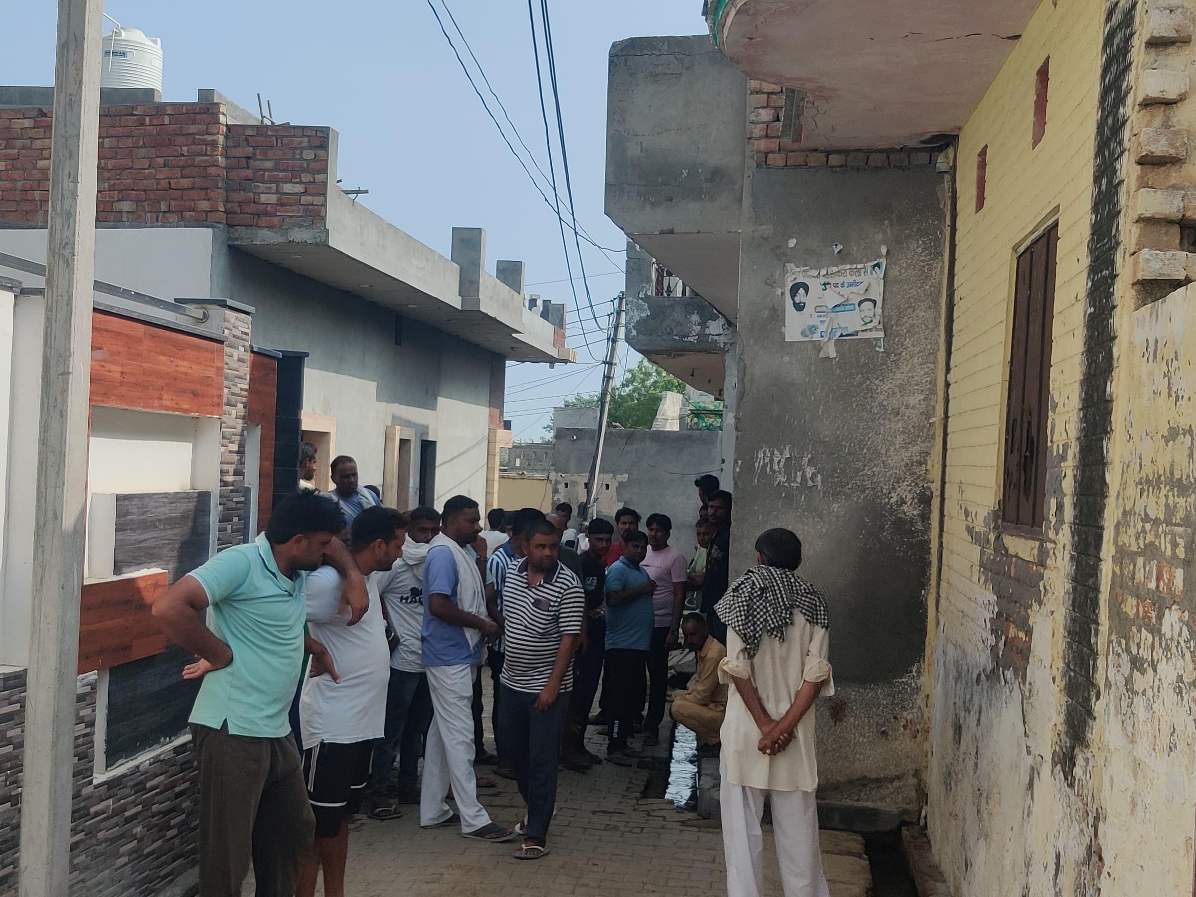 A crowd of villagers on the spot after the murder of a young man in Badsikri Kalan village.