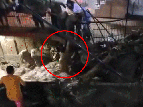 People rescuing a woman trapped in the lower floor of the house after cloudburst in the market
