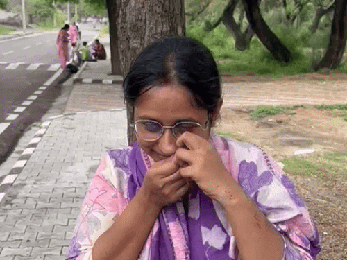 The young woman extracts noj pin before the entry at the examination center in Hisar.