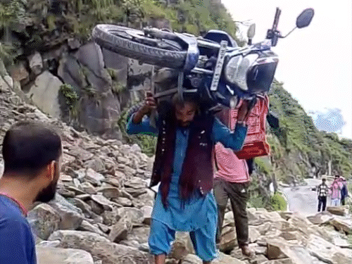 The young man carrying the bike on his shoulder. Video viral on social media.