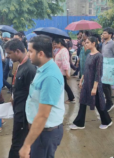 Doctors performing with umbrellas in rain.