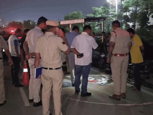 Police officers collecting evidence from the spot at night in Gurugram.