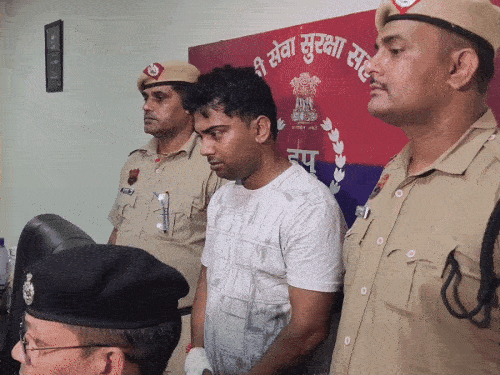 Accused youth standing in police custody.