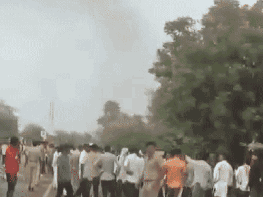 People stored on the middle road and the burning bike.