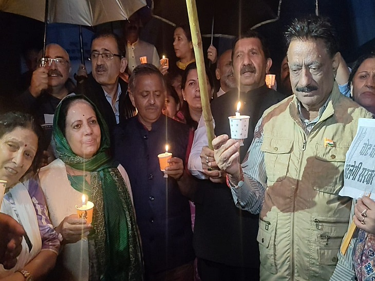 Congress leader taking out candle light march in rain on the ridge