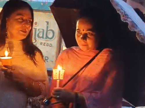 Congress leader taking out a candle march with slogan 'Vote thieves- Gaddi Chhup' on Shimla's ridge