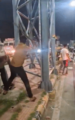 The toll workers tied the army soldier to the pillar and beat him with a stick.