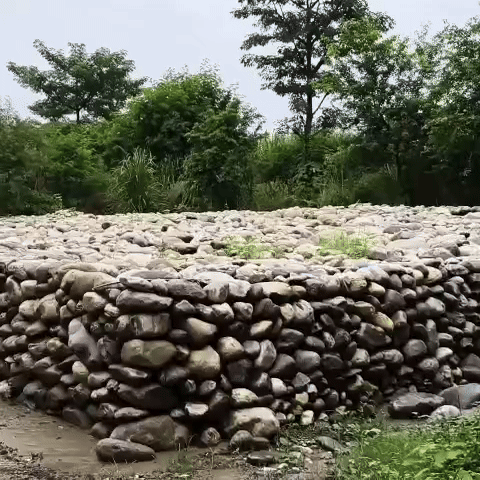 Stones placed along the river to strengthen the tracks.