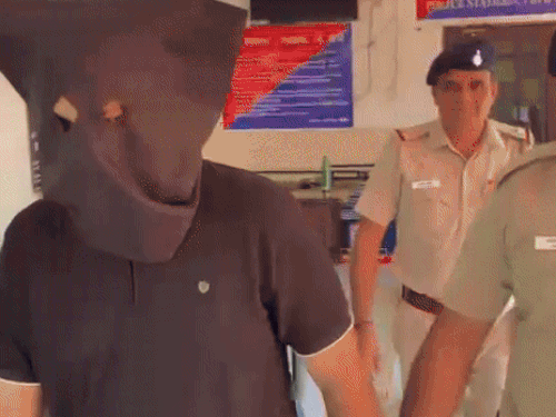 आरोपी को ले जाती पुलिस।