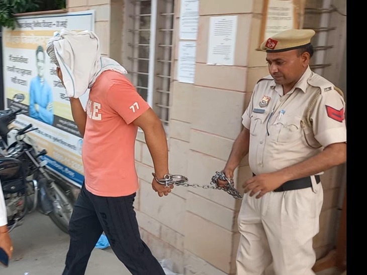 Police carry the accused.