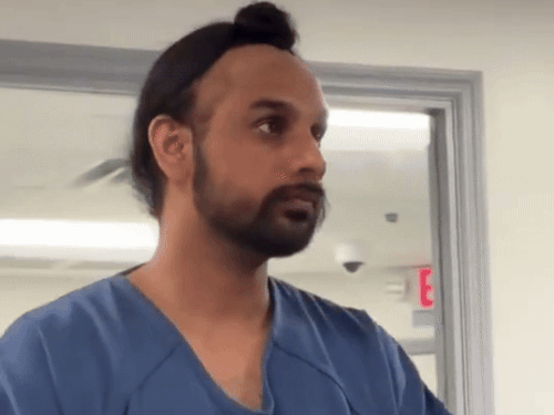 Harjinder standing in front of the judge during the trial.