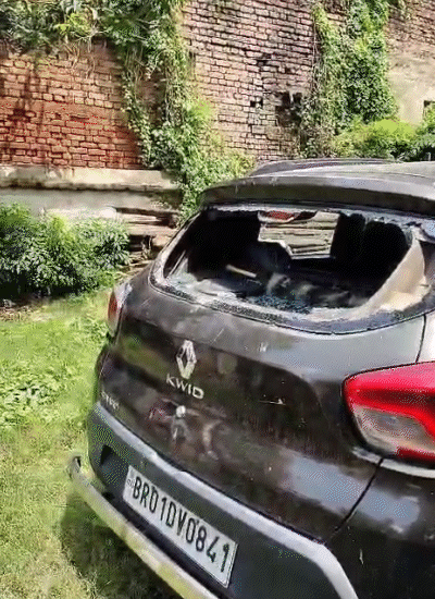 The car parked in Sadaqat Ashram was vandalized. The glass of the car broke.