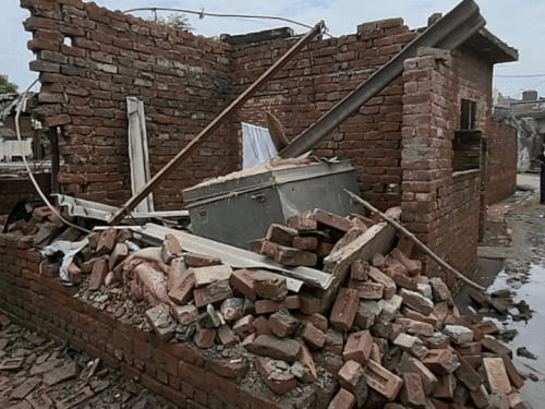 Broken houses are seen in every street of the village.