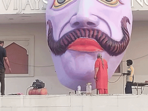 Painting on the face of Ravana's effigy.