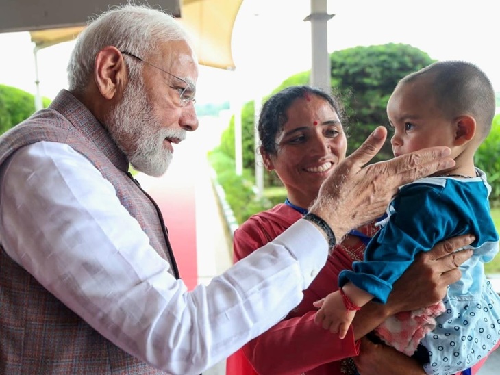 A 1 -year -old girl Nitika Kumari and PM Modi in the lap of Bua Kirana Devi.
