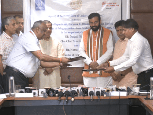 Officers shaking hands after the agreement with Alliance Air Oviation Limited.