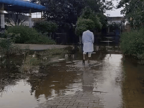 Youth passing through waterlogging in Sugar Mandori school
