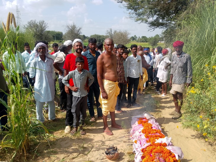 बुजुर्ग के शव को जमीन पर रखकर खड़े परिजन।