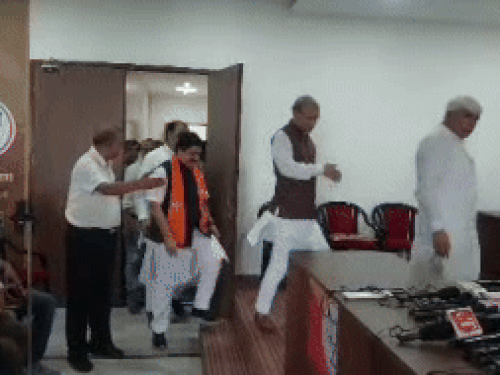 BJP national spokesperson Prem Shukla arrived to talk to reporters.