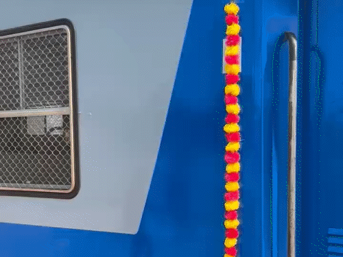 मेमू पैसेंजर ट्रेन को फूल मालाओं से सजाया गया है।