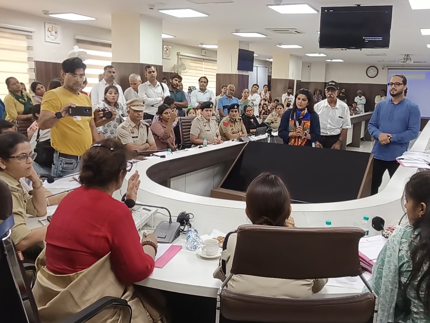 Renu Bhatia, chairperson of the Women's Commission, hearing the program.