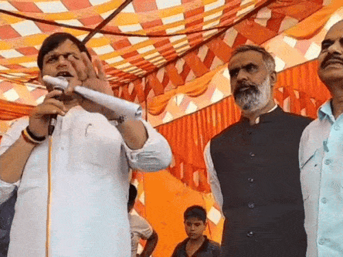 Minister Gaurav Gautam talking to people from the stage.