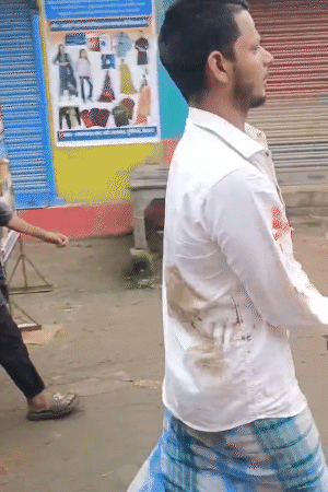 This is a Muslim youth who is accused of breaking the idol. After beating it, the mob tied it up and handed it over to the police.