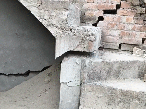 Due to floods, there have been big cracks in people's homes.
